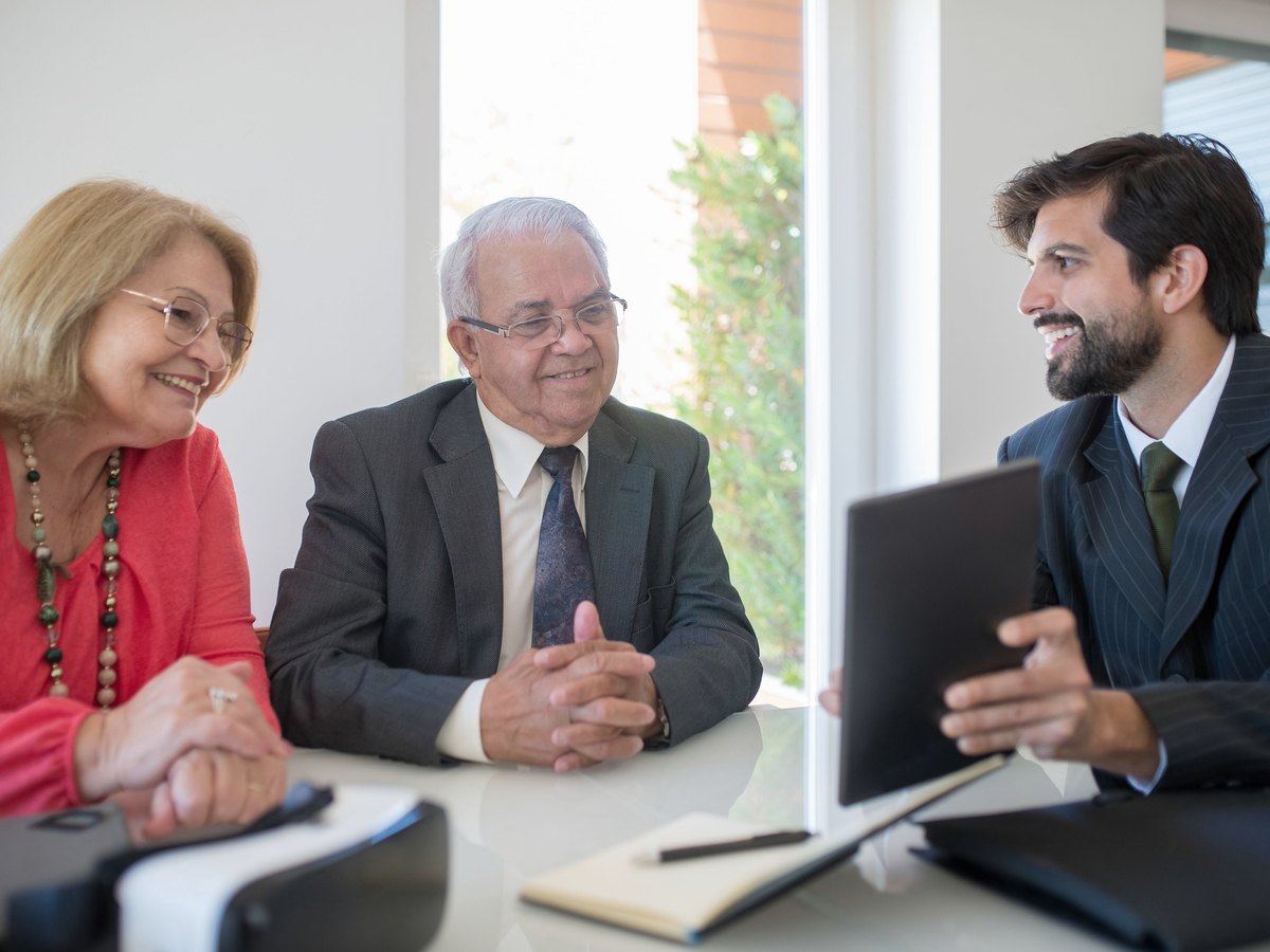 Advisers discussing a client's project at a meeting table
